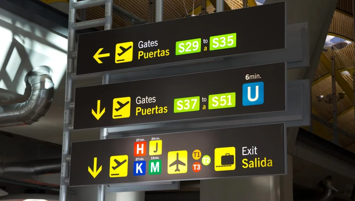 A sign directing passengers in an airport terminal.