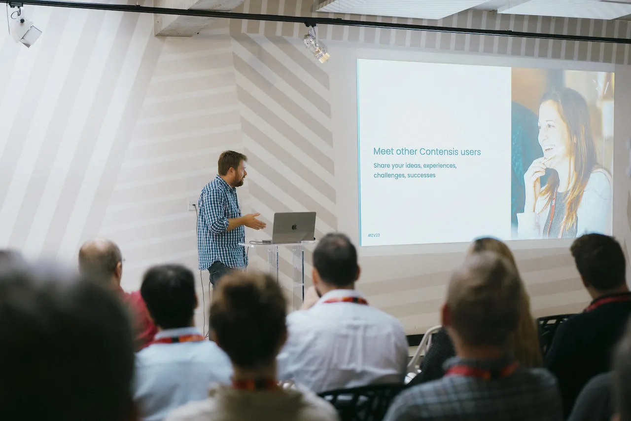 A man stood presenting to a crowd