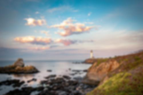 The coastal landscape heavily blurred
