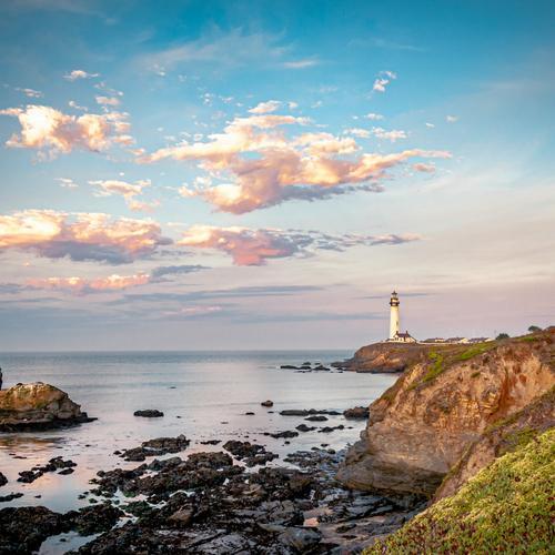 The coastal landscape cropped to a square from the centre, with the lighthouse near the right edge