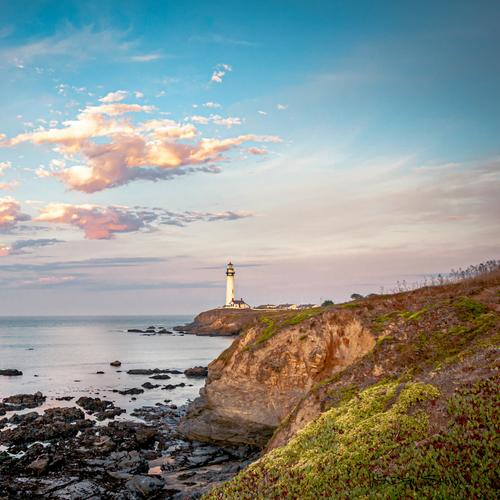 The coastal landscape cropped to a square from the right, keeping the lighthouse and the headland